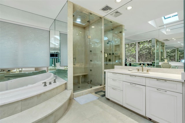 74 Woods Dr, Roslyn, NY 11576 - full bath with a skylight, a stall shower, vanity, a bath, and recessed lighting