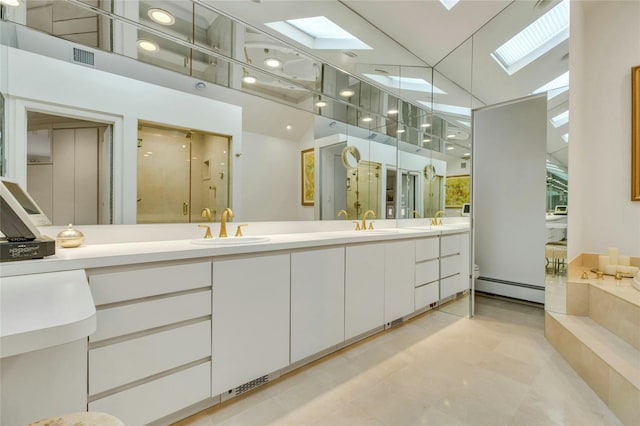 74 Woods Dr, Roslyn, NY 11576 - full bath with a baseboard radiator, a skylight, double vanity, and a shower stall