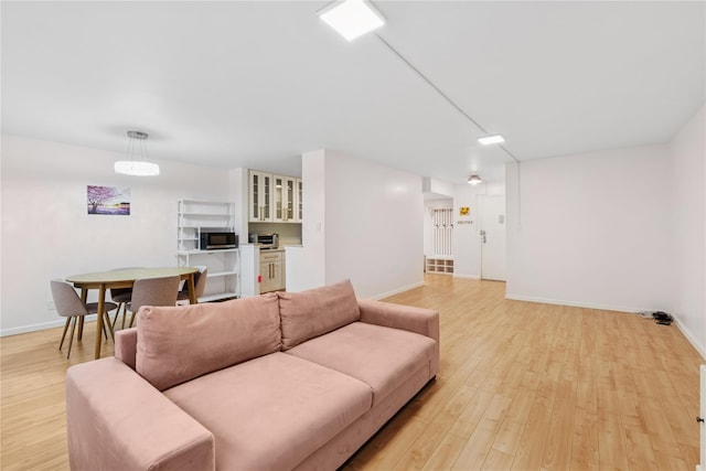 102-30 66th Rd Unit 1G, Forest Hills, NY 11375 - living room featuring light wood-style floors and baseboards