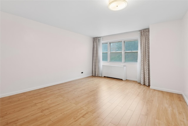 102-30 66th Rd Unit 1G, Forest Hills, NY 11375 - spare room featuring light wood-style floors and radiator