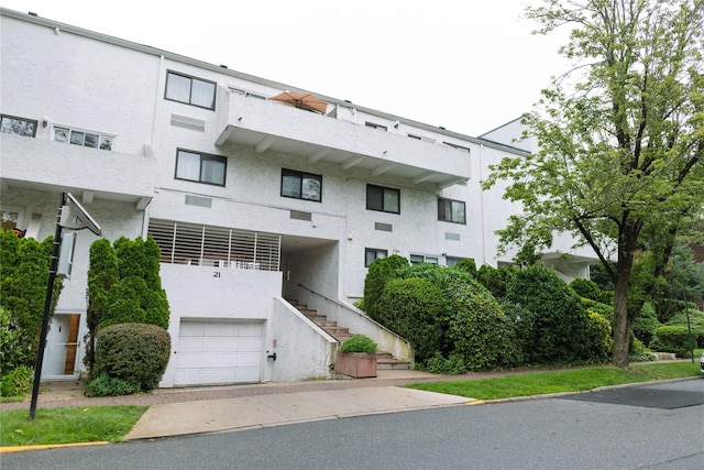 21 Canterbury Rd Unit 3, Great Neck, NY 11021 - view of building exterior with a garage and stairway