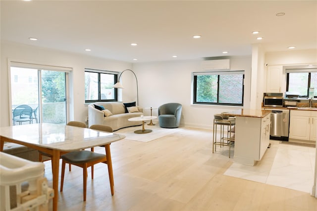 21 Canterbury Rd Unit 3, Great Neck, NY 11021 - dining room with a wall mounted AC, recessed lighting, and light wood finished floors