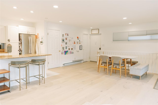 21 Canterbury Rd Unit 3, Great Neck, NY 11021 - dining area with light wood-type flooring, recessed lighting, and a baseboard heating unit