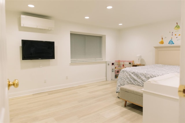 21 Canterbury Rd Unit 3, Great Neck, NY 11021 - bedroom featuring a wall unit AC, light wood-style flooring, and recessed lighting