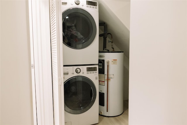 21 Canterbury Rd Unit 3, Great Neck, NY 11021 - laundry room featuring electric water heater, estacked washer and dryer, and light wood-type flooring