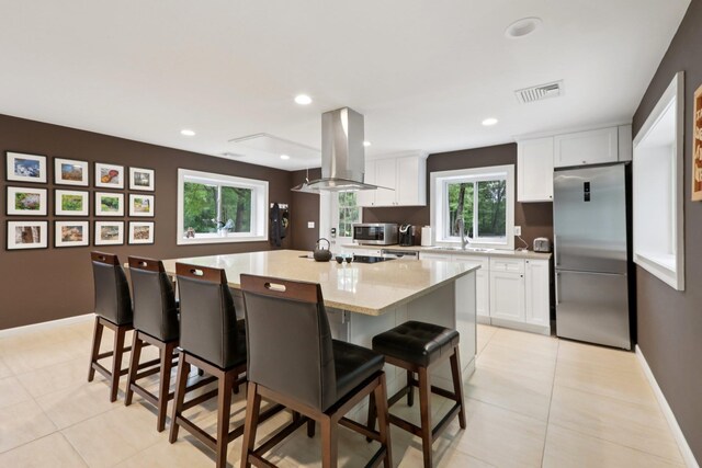 160 S Mountain Rd, New City, NY 10956 - kitchen with stainless steel appliances, island range hood, white cabinetry, light tile patterned flooring, and recessed lighting