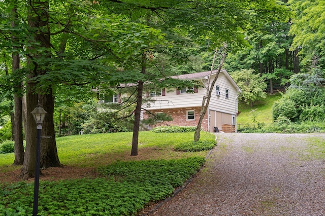 39 Knollwood Ln, Cold Spring, NY 10516 - view of front of home with brick siding, driveway, and a front lawn