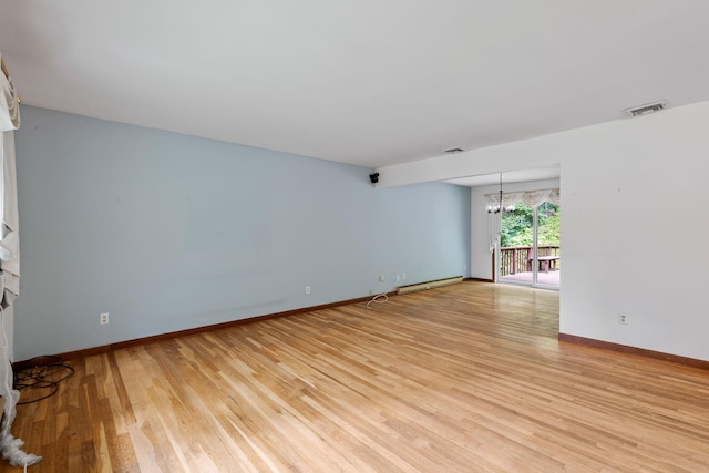 39 Knollwood Ln, Cold Spring, NY 10516 - unfurnished living room featuring a chandelier, light wood-type flooring, and a baseboard radiator