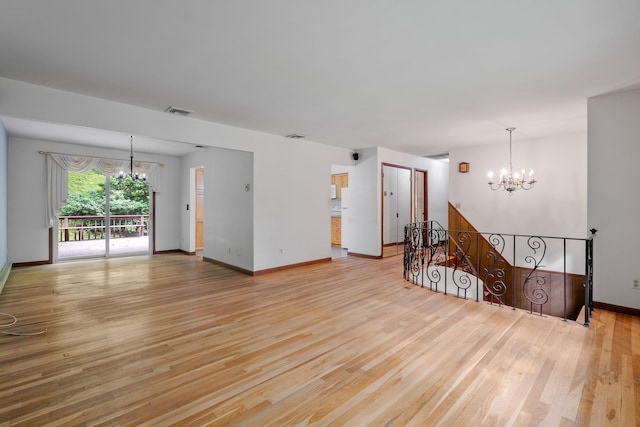 39 Knollwood Ln, Cold Spring, NY 10516 - unfurnished living room featuring a chandelier and light wood-style flooring
