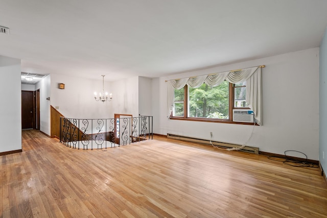 39 Knollwood Ln, Cold Spring, NY 10516 - unfurnished room with a baseboard radiator, a chandelier, wood-type flooring, and cooling unit