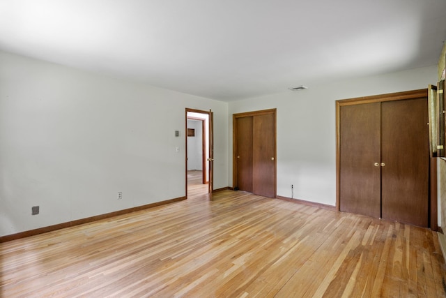 39 Knollwood Ln, Cold Spring, NY 10516 - unfurnished bedroom featuring multiple closets and light wood-style floors