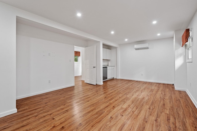 39 Knollwood Ln, Cold Spring, NY 10516 - unfurnished living room with a wall mounted AC, light wood finished floors, and recessed lighting