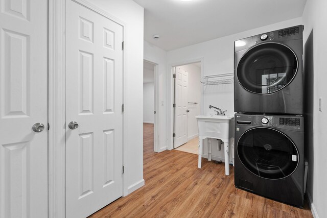 39 Knollwood Ln, Cold Spring, NY 10516 - washroom with stacked washer and clothes dryer and light wood-style floors