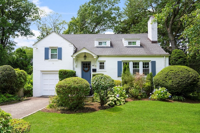 44 Kingsbury Rd, New Rochelle, NY 10804 - view of front of house featuring an attached garage, a chimney, a front lawn, asphalt driveway, and roof with shingles