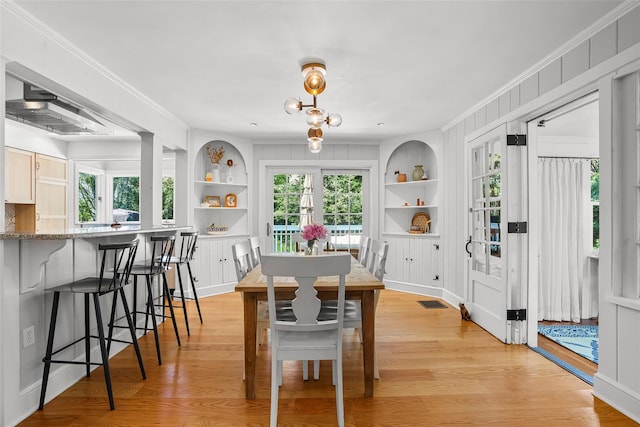44 Kingsbury Rd, New Rochelle, NY 10804 - dining area with built in shelves, ornamental molding, light wood-style floors, and healthy amount of natural light