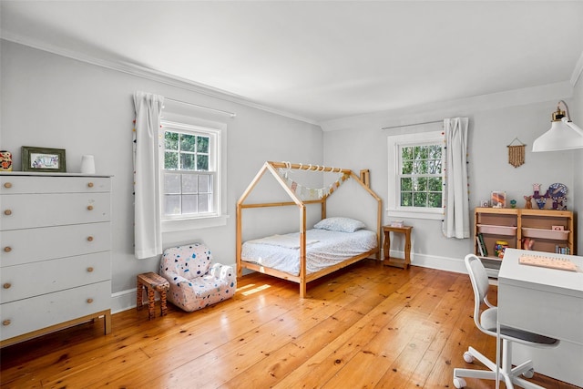 44 Kingsbury Rd, New Rochelle, NY 10804 - bedroom with multiple windows, light wood-style floors, crown molding, and a desk