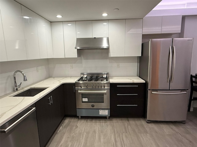 158-15 Union Tpke Unit 204N, Fresh Meadows, NY 11366 - kitchen featuring stainless steel appliances, under cabinet range hood, modern cabinets, white cabinets, and light wood finished floors