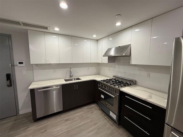 158-15 Union Tpke Unit 204N, Fresh Meadows, NY 11366 - kitchen featuring stainless steel appliances, under cabinet range hood, modern cabinets, white cabinetry, and recessed lighting