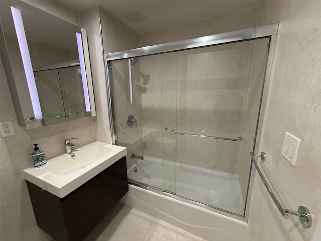 158-15 Union Tpke Unit 204N, Fresh Meadows, NY 11366 - bathroom featuring vanity, combined bath / shower with glass door, tile patterned flooring, and tile walls