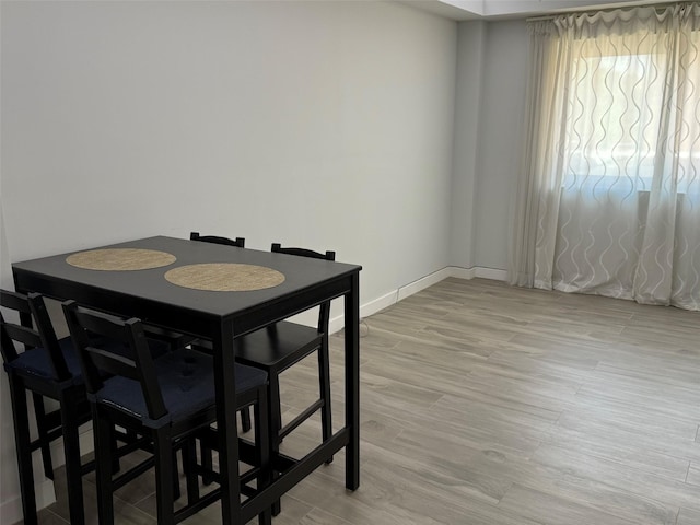 158-15 Union Tpke Unit 204N, Fresh Meadows, NY 11366 - dining area featuring light wood-style flooring and baseboards