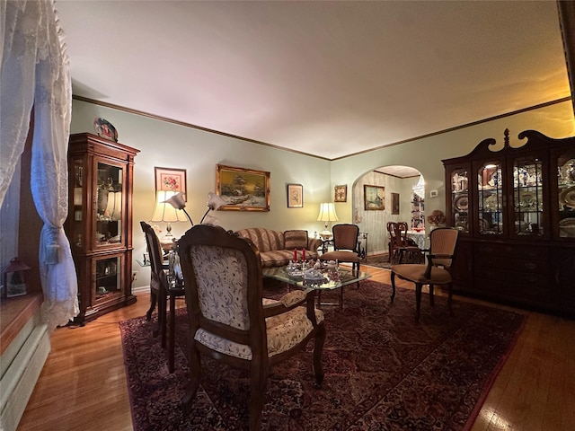 82-48 Eliot Ave, Middle Village, NY 11379 - living room featuring arched walkways, wood finished floors, and crown molding
