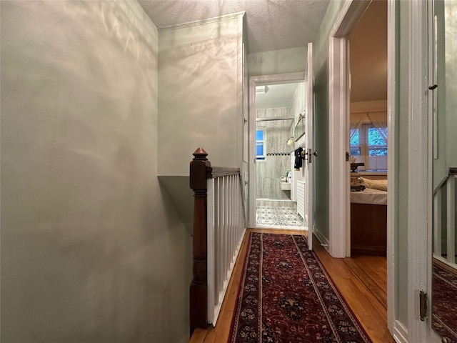 82-48 Eliot Ave, Middle Village, NY 11379 - hall with wood finished floors, an upstairs landing, and a textured ceiling
