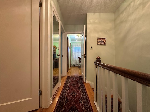 82-48 Eliot Ave, Middle Village, NY 11379 - hall featuring wood finished floors and a textured ceiling