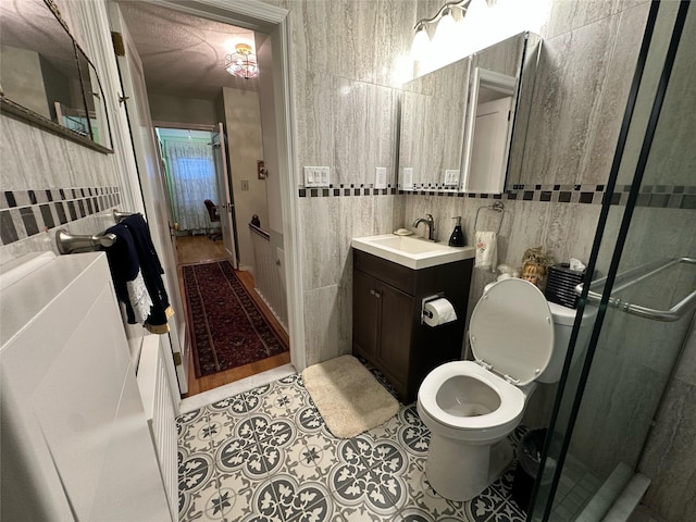 82-48 Eliot Ave, Middle Village, NY 11379 - full bathroom with tile walls, vanity, a shower stall, and tile patterned flooring