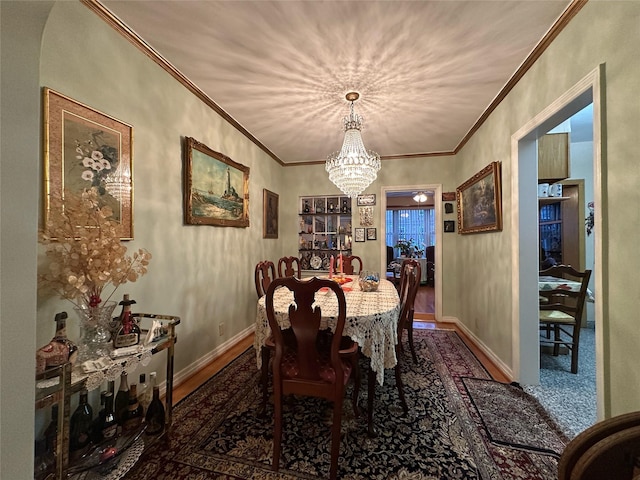 82-48 Eliot Ave, Middle Village, NY 11379 - dining space with a chandelier, crown molding, and wood finished floors