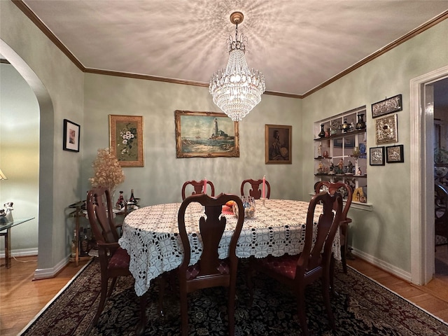 82-48 Eliot Ave, Middle Village, NY 11379 - dining space with arched walkways, wood finished floors, a chandelier, and crown molding