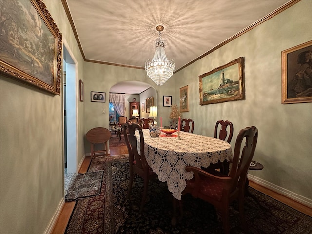 82-48 Eliot Ave, Middle Village, NY 11379 - dining area with wood finished floors, arched walkways, crown molding, and a chandelier