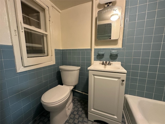 82-48 Eliot Ave, Middle Village, NY 11379 - full bath with tile walls, vanity, a wainscoted wall, and a tub to relax in