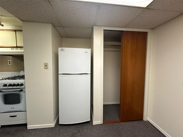 82-48 Eliot Ave, Middle Village, NY 11379 - kitchen with freestanding refrigerator, stainless steel gas range oven, dark colored carpet, ventilation hood, and a drop ceiling