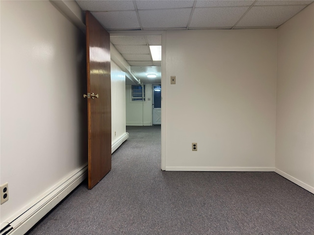 82-48 Eliot Ave, Middle Village, NY 11379 - carpeted empty room featuring a baseboard heating unit and a paneled ceiling