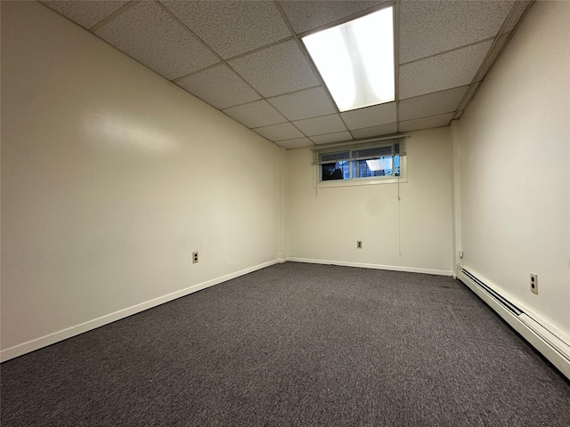82-48 Eliot Ave, Middle Village, NY 11379 - unfurnished room featuring a paneled ceiling, a baseboard heating unit, and dark carpet