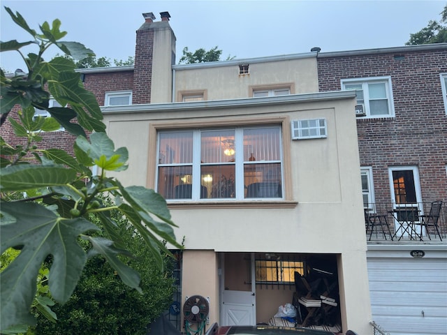 82-48 Eliot Ave, Middle Village, NY 11379 - rear view of property with stucco siding and a chimney
