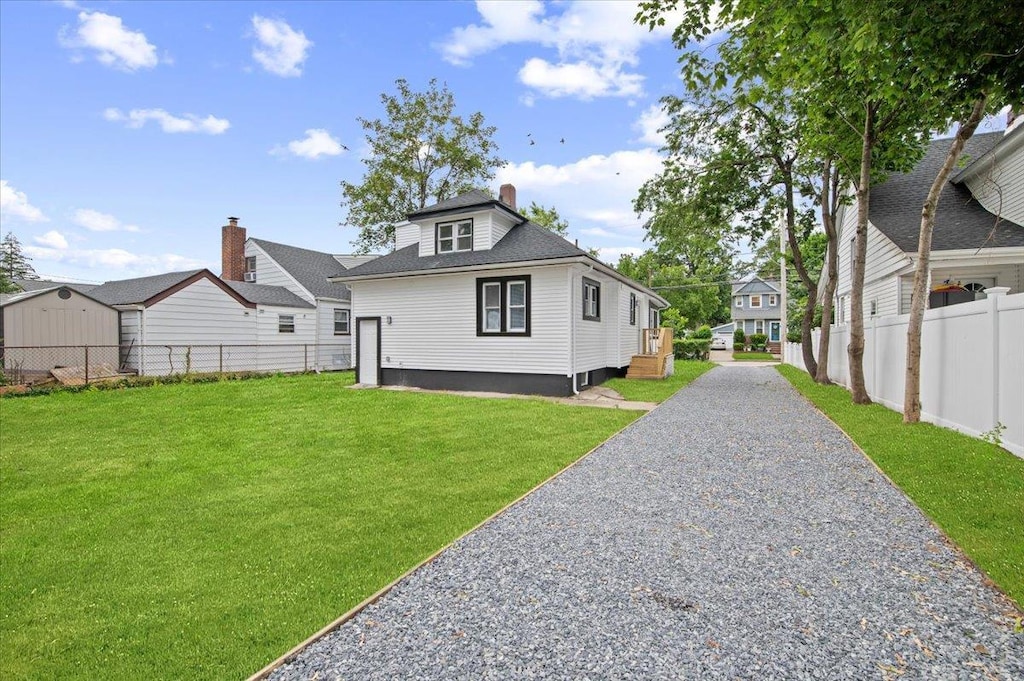 18 Evans Ave, Freeport, NY 11520 - back of property with a residential view and a shingled roof