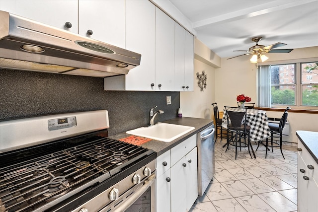 151-25 88th St Unit 1D, Howard Beach, NY 11414 - kitchen featuring appliances with stainless steel finishes, under cabinet range hood, light marble finish flooring, ceiling fan, and dark countertops