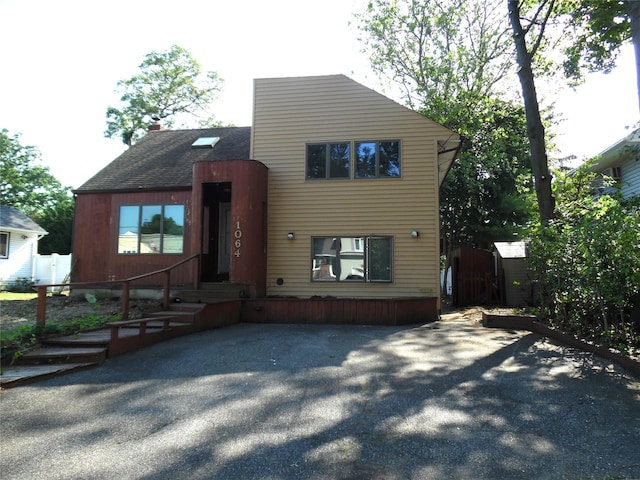 1064 Barbara Ct, North Bellmore, NY 11710 - view of front of property with a shingled roof and a chimney