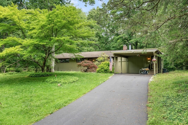 41 Colburn Dr, Poughkeepsie, NY 12603 - view of front of property featuring a chimney, driveway, and a front lawn
