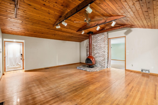 41 Colburn Dr, Poughkeepsie, NY 12603 - unfurnished living room with rail lighting, a wood stove, wood ceiling, lofted ceiling, and wood finished floors