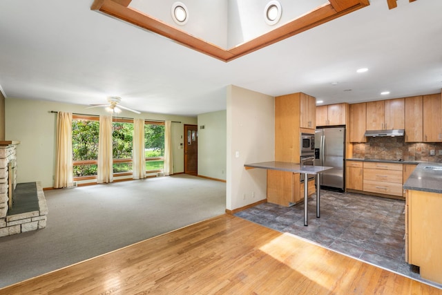 41 Colburn Dr, Poughkeepsie, NY 12603 - kitchen with appliances with stainless steel finishes, open floor plan, dark countertops, a kitchen breakfast bar, and ceiling fan