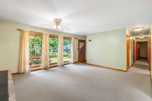 41 Colburn Dr, Poughkeepsie, NY 12603 - unfurnished living room with healthy amount of natural light, a ceiling fan, and light carpet
