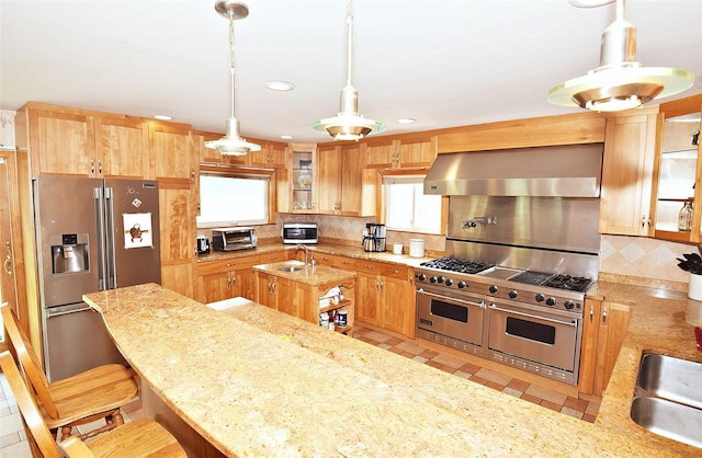 4723 164th St, Flushing, NY 11358 - kitchen with appliances with stainless steel finishes, wall chimney range hood, light stone counters, decorative backsplash, and glass insert cabinets