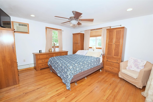 4723 164th St, Flushing, NY 11358 - bedroom featuring light wood-style flooring, a wall mounted air conditioner, a baseboard radiator, recessed lighting, and a ceiling fan