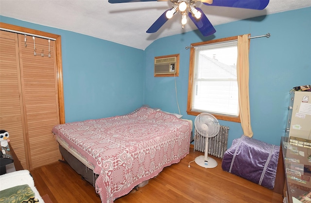 4723 164th St, Flushing, NY 11358 - bedroom with radiator, lofted ceiling, wood finished floors, a closet, and a wall mounted AC