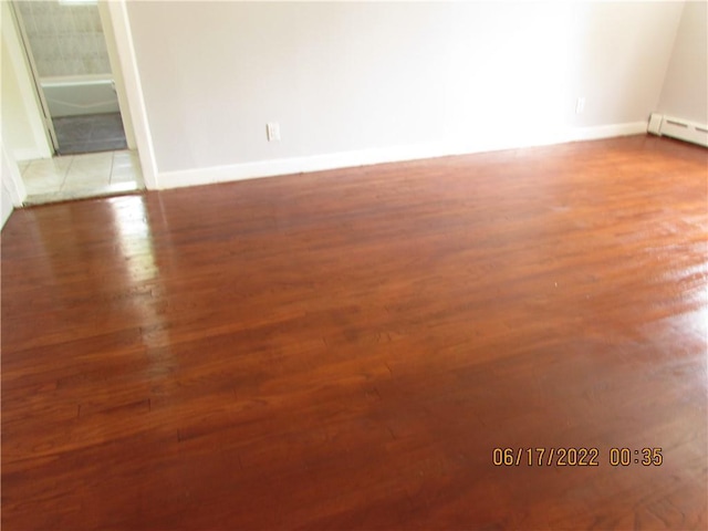 2 Leffingwell Pl, New Rochelle, NY 10801 - empty room featuring wood finished floors and a baseboard radiator