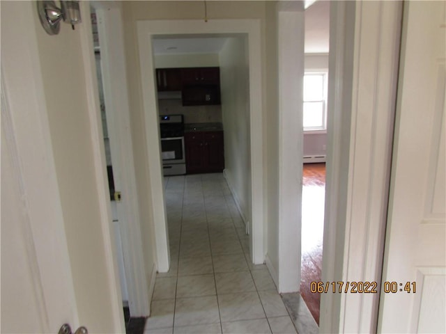 2 Leffingwell Pl, New Rochelle, NY 10801 - hallway with light tile patterned flooring and a baseboard heating unit