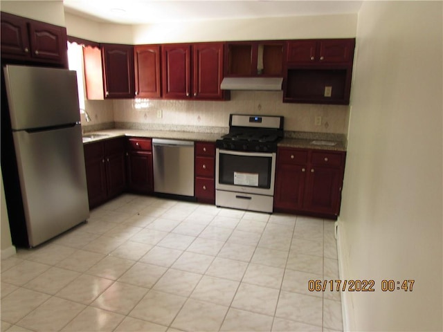 2 Leffingwell Pl, New Rochelle, NY 10801 - kitchen featuring stainless steel appliances, ventilation hood, dark brown cabinets, light tile patterned flooring, and tasteful backsplash