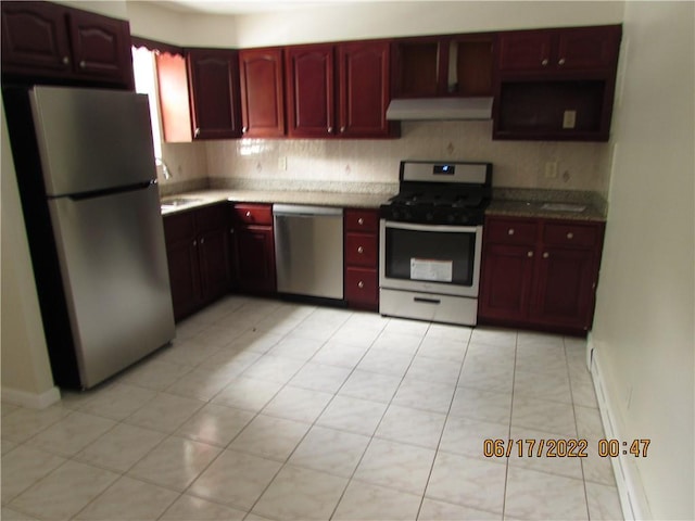 2 Leffingwell Pl, New Rochelle, NY 10801 - kitchen with appliances with stainless steel finishes, dark brown cabinets, wall chimney exhaust hood, light countertops, and light tile patterned floors